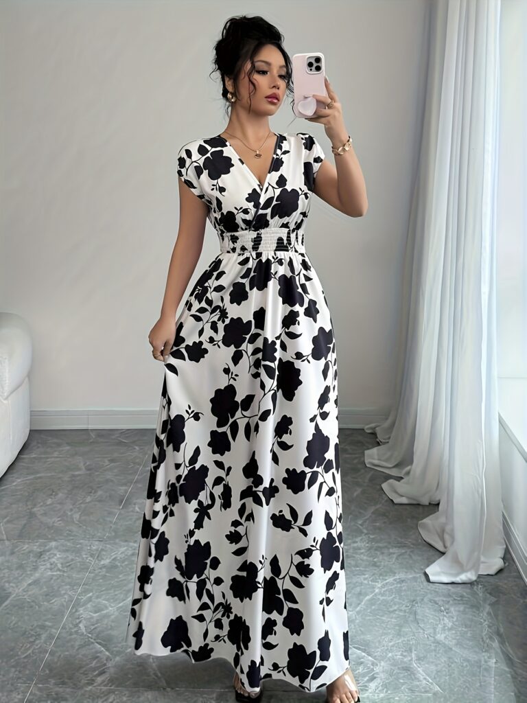 Casablanca Floral Maxi Dress from Newness - Flowy maxi dress with vibrant floral print, ideal for summer.