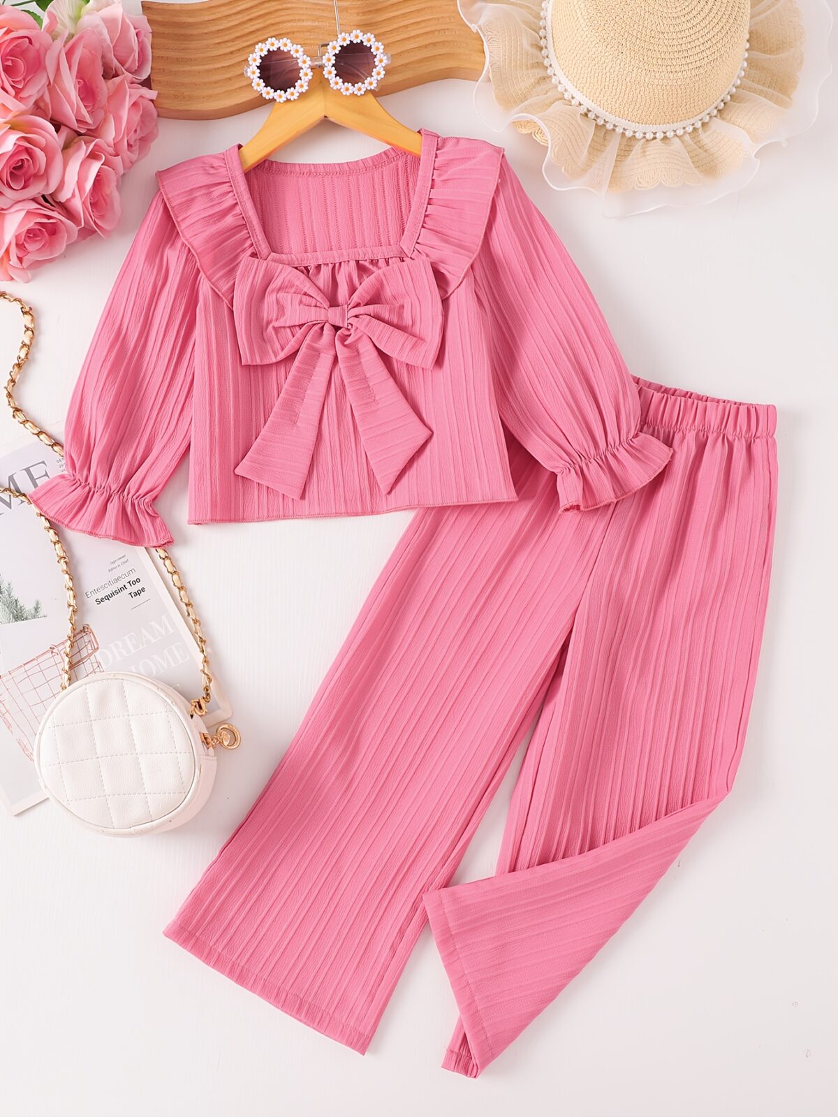 Adorable girls two piece outfit in breathable fabric featuring a charming bow detail and stylish wide leg pants perfect for autumn outings