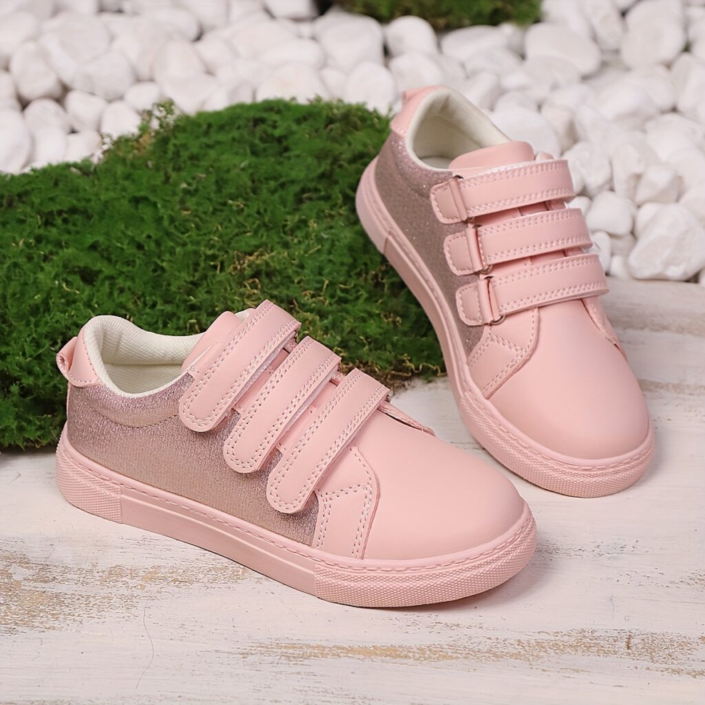 Adorable pink sneakers for girls, featuring a charming bow detail. Perfect for active play and everyday wear.