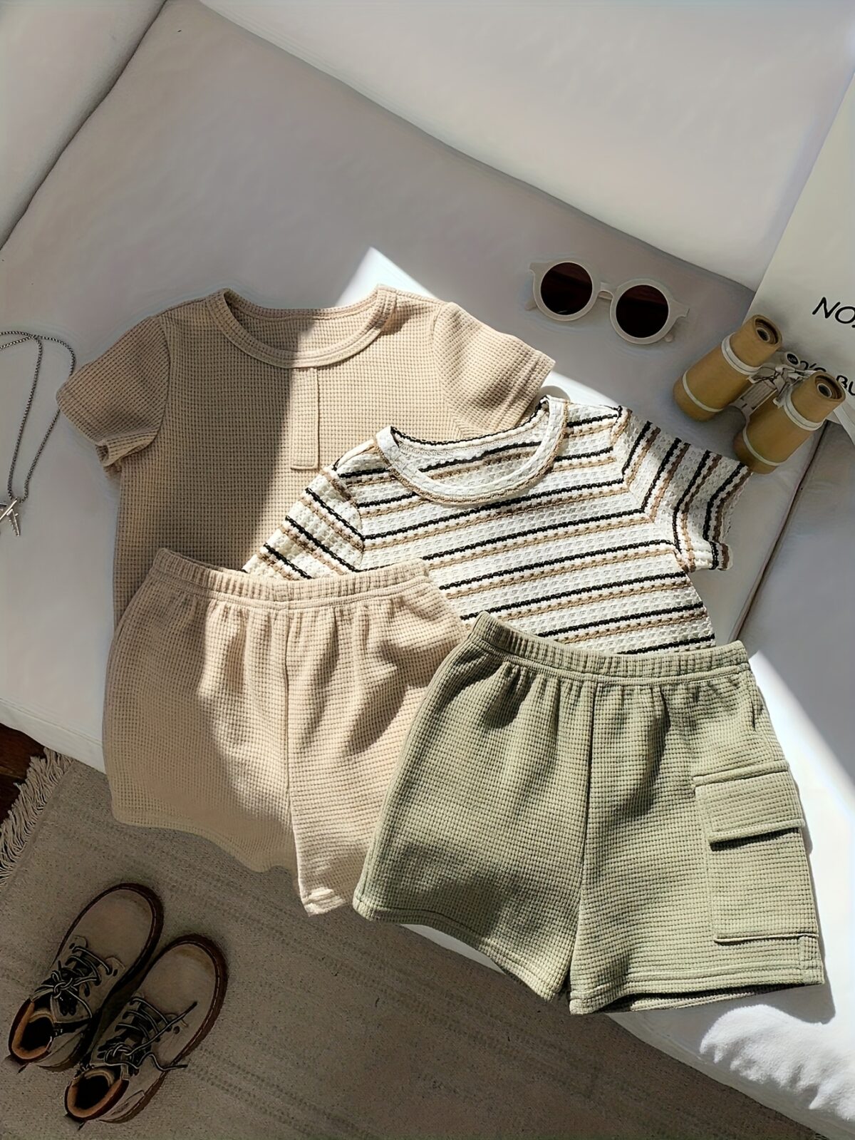 Adorable baby boy in a beige and green striped summer outfit set featuring a textured short sleeve top and matching shorts Perfect for warm weather