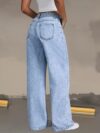 Model wearing Newness Dubai Breeze Wide Leg Jeans a light wash high waisted pair of wide leg jeans