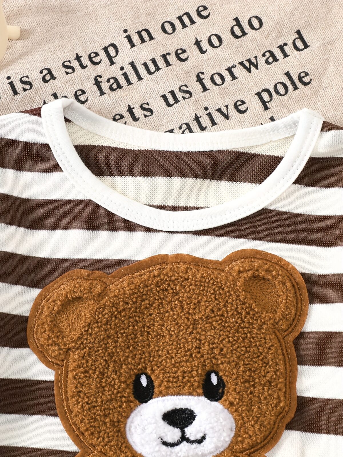 Adorable baby boy wearing Newness Cozy Cub Two Piece Set featuring a striped top with bear embroidery and matching shorts Perfect for spring and summer