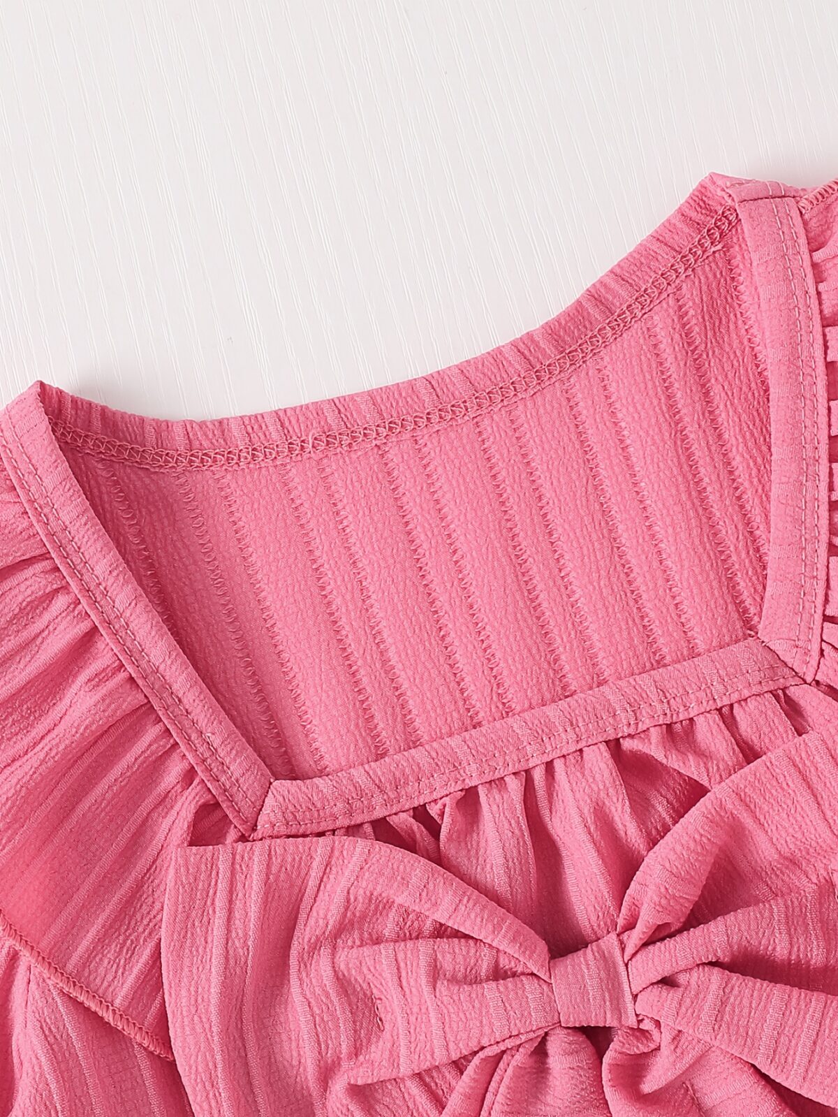 Adorable girls two piece outfit in breathable fabric featuring a charming bow detail and stylish wide leg pants perfect for autumn outings
