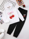 Adorable girl wearing a playful spring hues hooded sports suit featuring a charming cartoon print Perfect for spring adventures