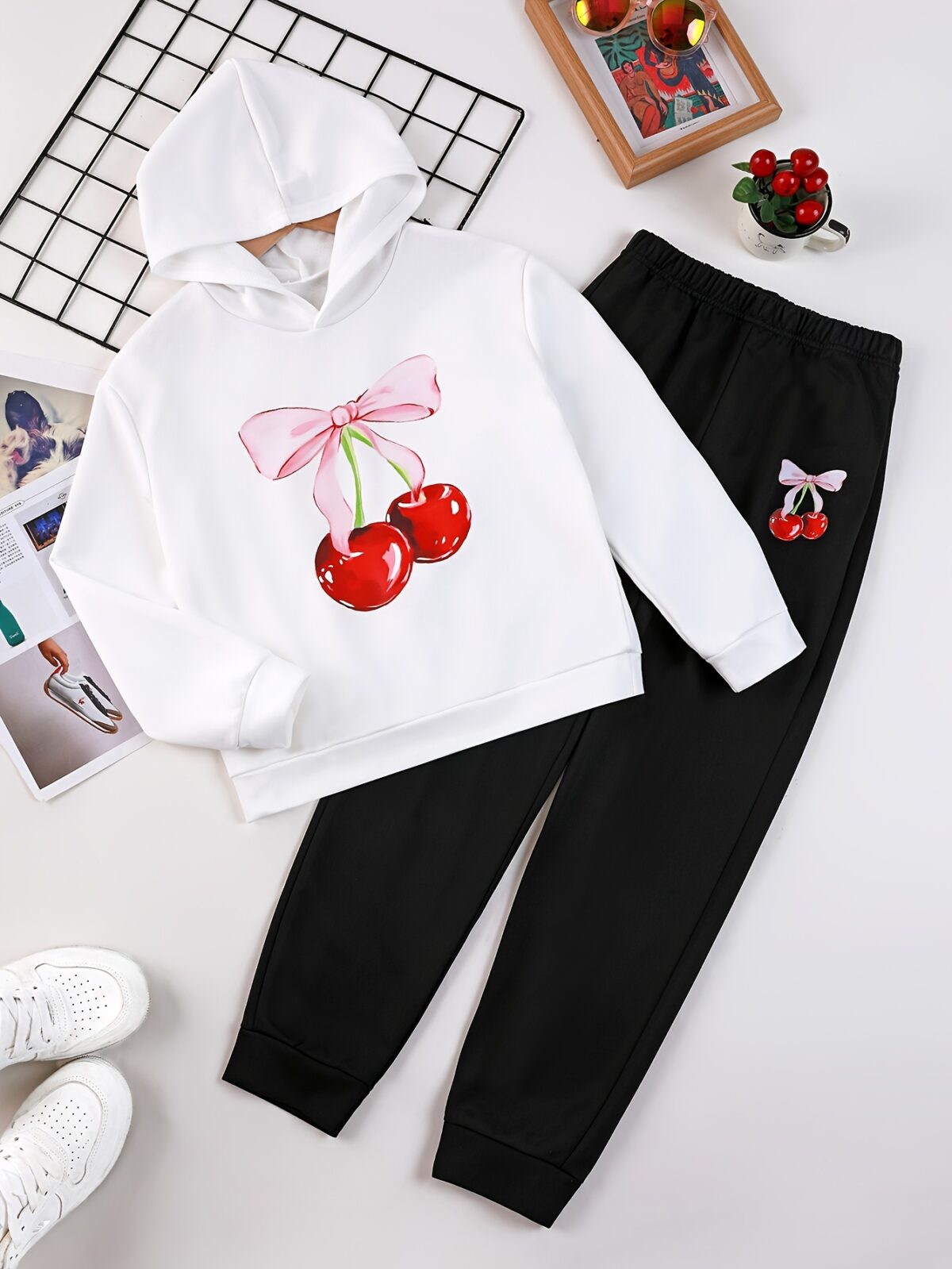 Adorable girl wearing a playful spring hues hooded sports suit featuring a charming cartoon print Perfect for spring adventures