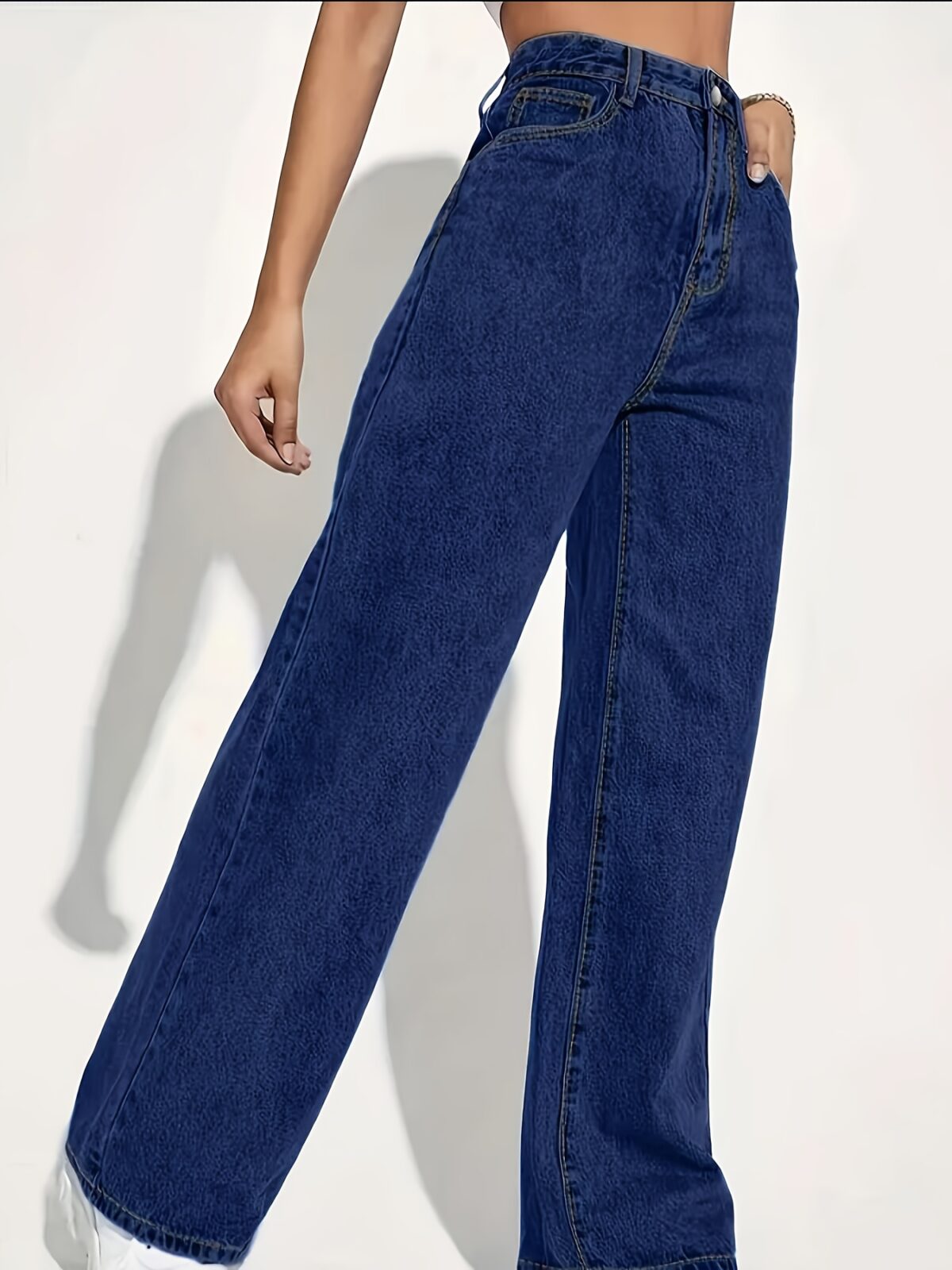 Model wearing Newness Dubai High Waisted Wide Leg Jeans a versatile pair of premium denim jeans in a flattering wide leg silhouette and high waisted fit perfect for any season