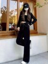 Newness Midnight Hour Black High Waisted Jeans A model showcasing the flattering fit and chic style of the jeans