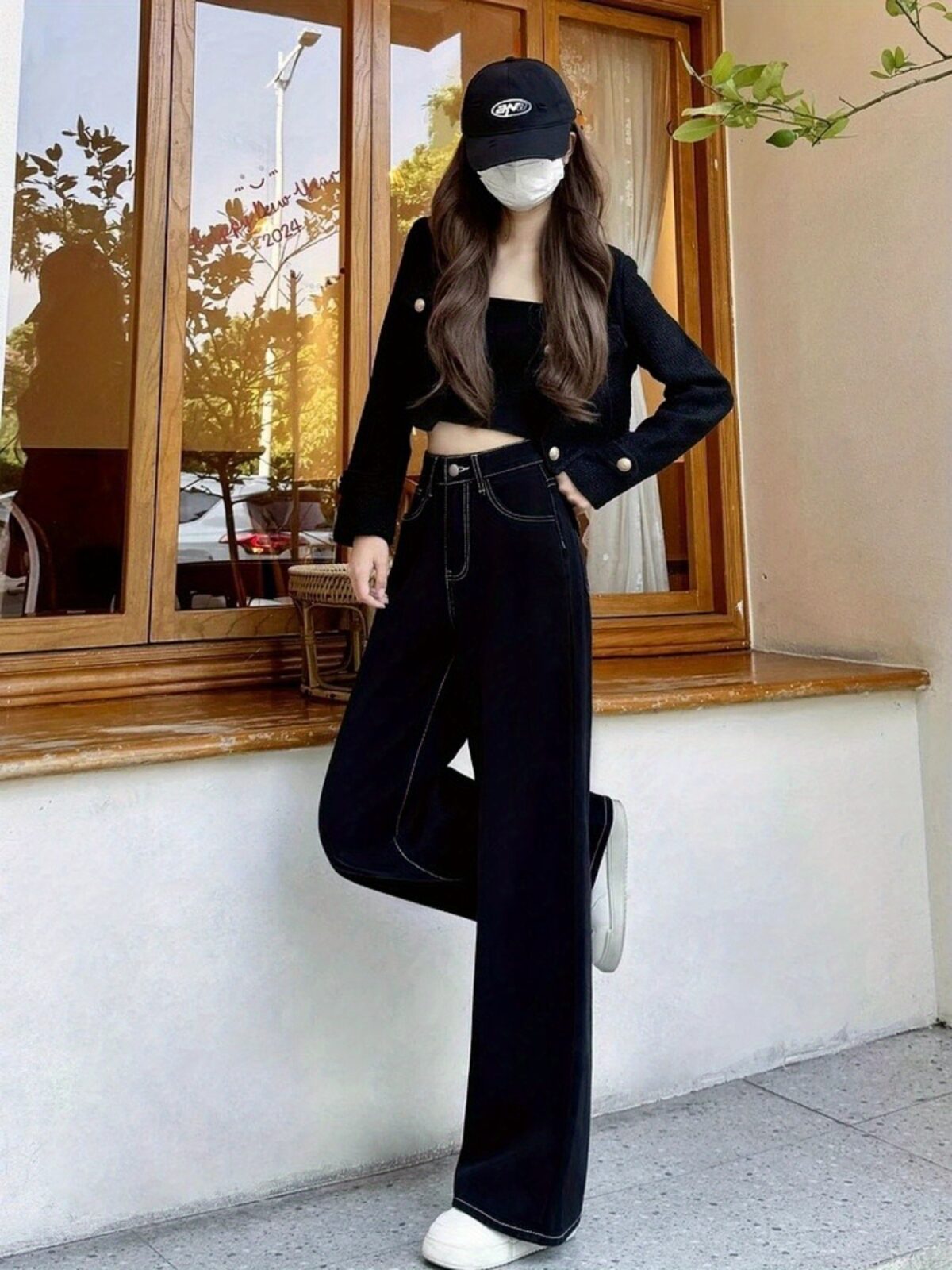 Newness Midnight Hour Black High Waisted Jeans A model showcasing the flattering fit and chic style of the jeans