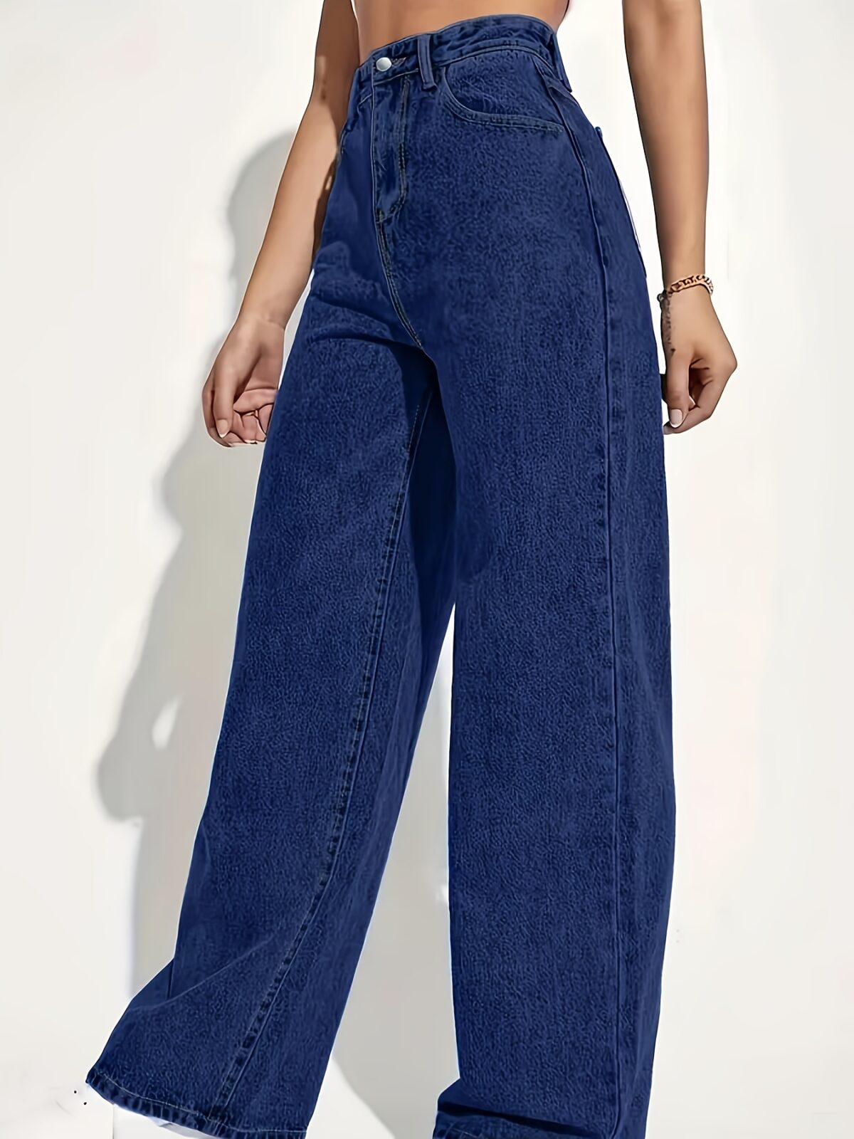 Model wearing Newness Dubai High Waisted Wide Leg Jeans a versatile pair of premium denim jeans in a flattering wide leg silhouette and high waisted fit perfect for any season
