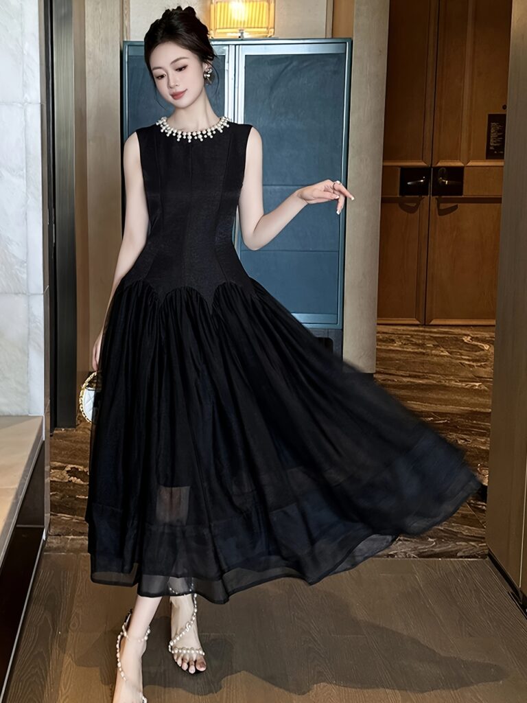 Model wearing the Newness Parisian Nights Black Maxi Dress, a chic and sophisticated black maxi dress perfect for special occasions.