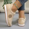 Womens classic flannel low top lace up sneakers with rubber sole shown from the side in a neutral color
