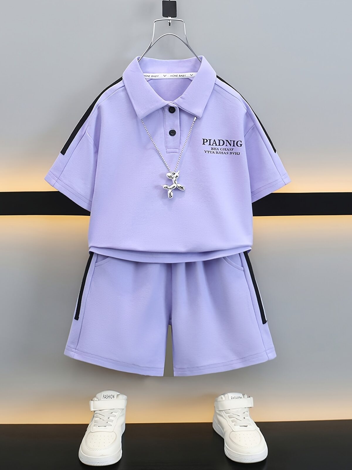 Stylish purple sports set for boys aged 12 and under Breathable polyester fabric ensures comfort and freedom of movement Perfect for summer activities
