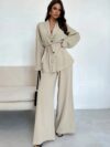 The Newness Milan Tie Waist Blazer Set a chic two piece outfit featuring a tailored blazer and matching pants cinched at the waist for a flattering silhouette Perfect for work or weekend