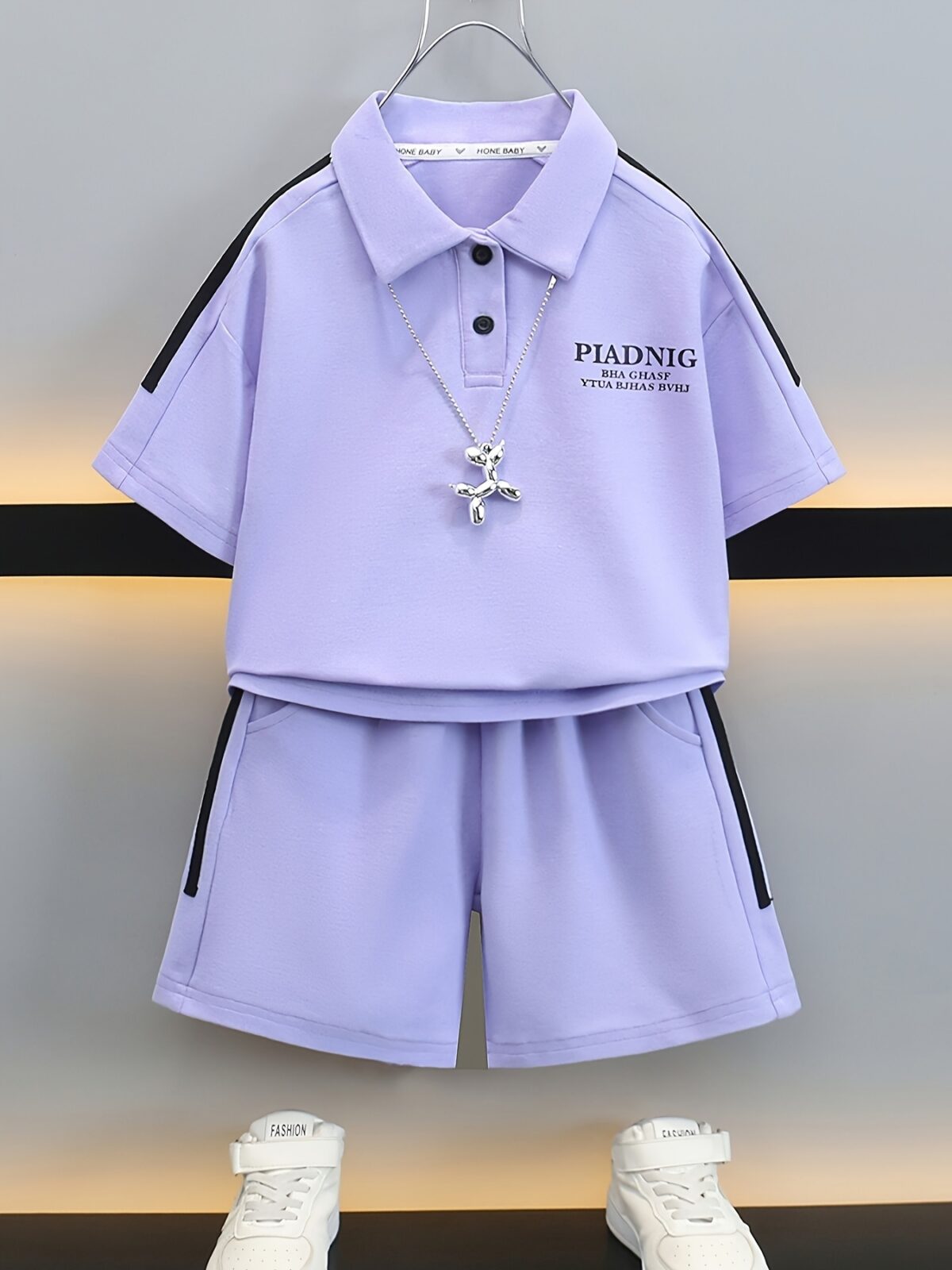 Stylish purple sports set for boys aged 12 and under Breathable polyester fabric ensures comfort and freedom of movement Perfect for summer activities