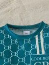 Stylish toddler boy wearing a trendy color block two piece outfit perfect for spring or autumn The outfit features a comfortable soft knit fabric in a vibrant color block design