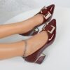 Womens black Mary Jane heels with gold buckle straps and chunky mid heel