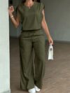 Model wearing the Newness Effortless Chic Sleeveless Wide Leg Set a stylish and comfortable two piece outfit featuring a sleeveless top and wide leg pants in luxurious polyester