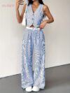 The Newness Riviera Striped Trouser Set in a flattering pose showcasing its relaxed fit and chic style Model is wearing the matching top and trousers