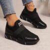 Womens black slip on sneakers with golden accents showcasing the breathable knit upper and flexible sole