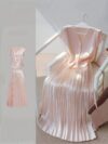 Flatlay of the Newness Bisous Rosé pink pleated midi set showcasing the skirt and top separately and together The set is a beautiful shade of pink and features delicate pleats