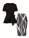 The Newness Cairo Tie Bow Two Piece Set A sophisticated modern two piece outfit featuring a stylish tie bow detail perfect for any occasion