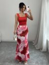 Model wearing the Newness Sunset Hues Ombre Skirt Set a chic two piece outfit featuring a gradient ombre effect in sunset colors The set includes a matching top and skirt showcasing a sophisticated and effortlessly cool summer style