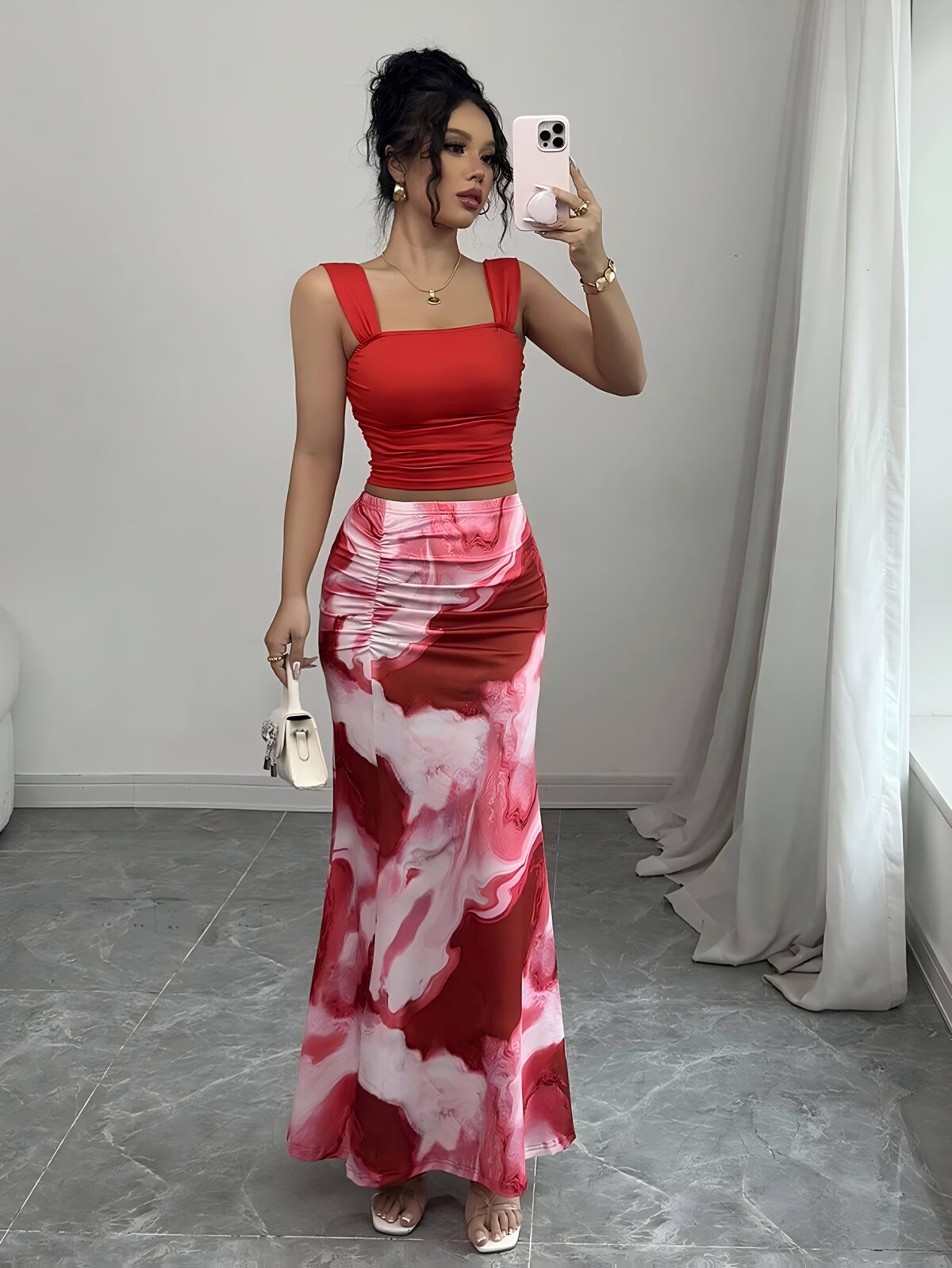 Model wearing the Newness Sunset Hues Ombre Skirt Set a chic two piece outfit featuring a gradient ombre effect in sunset colors The set includes a matching top and skirt showcasing a sophisticated and effortlessly cool summer style