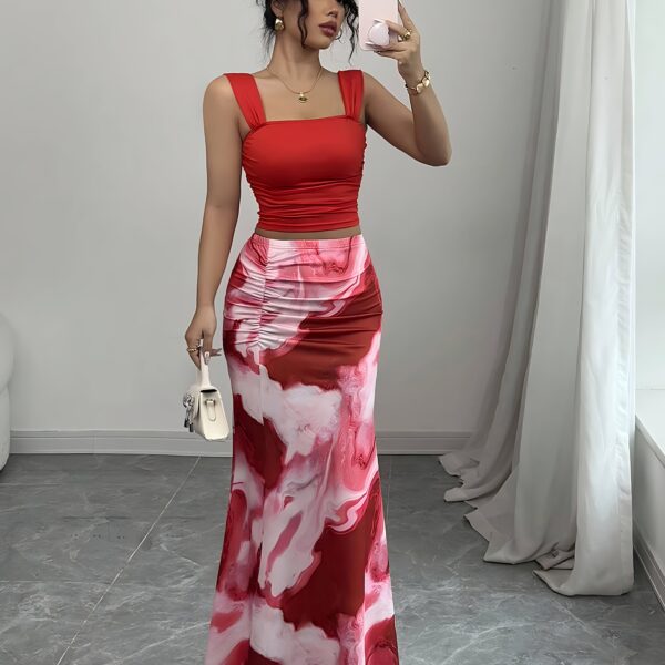 Model wearing the Newness Sunset Hues Ombre Skirt Set a chic two piece outfit featuring a gradient ombre effect in sunset colors The set includes a matching top and skirt showcasing a sophisticated and effortlessly cool summer style