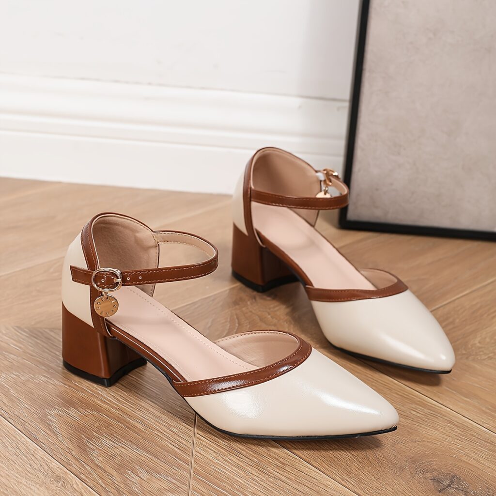 Newness Two-Tone Pointed Toe Heels in brown. These chic heels feature a chunky mid-heel, cut-out design, and brown cover straps. Perfect for any occasion.