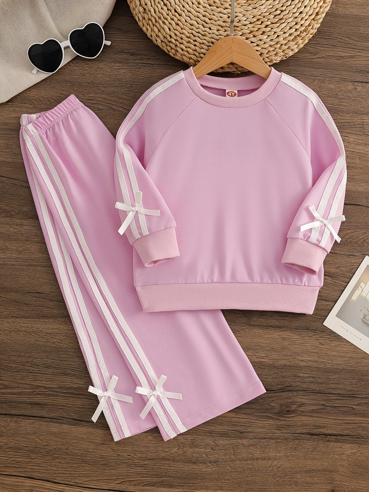 Girl wearing a stylish and comfortable two piece sweatpants set in soft stretchy fabric Perfect for everyday wear