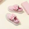 Pink and white girls princess sneakers with bows and heart accents showcasing their sparkly design and comfortable features Perfect for spring fall school or playdates