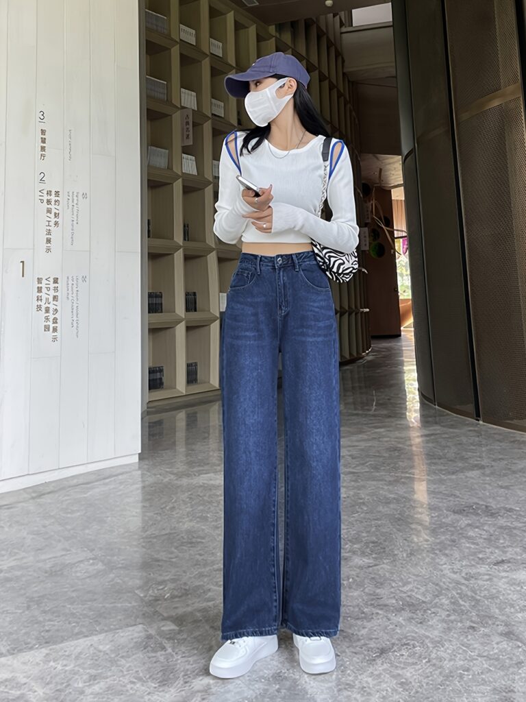 Flatlay of Newness' Parisian High-Waisted Wide Leg Jeans in a stylish setting. The durable denim and flattering wide-leg silhouette are highlighted.