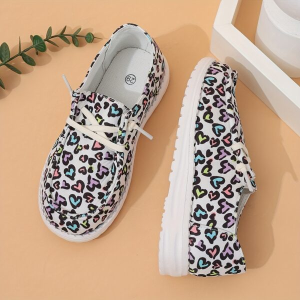 Adorable girls heart pattern loafers in a soft breathable fabric Perfect for everyday wear these slip on shoes offer both comfort and style