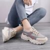 Pair of womens breathable mesh casual sneakers in white low top design with lace up closure and soft knit insole