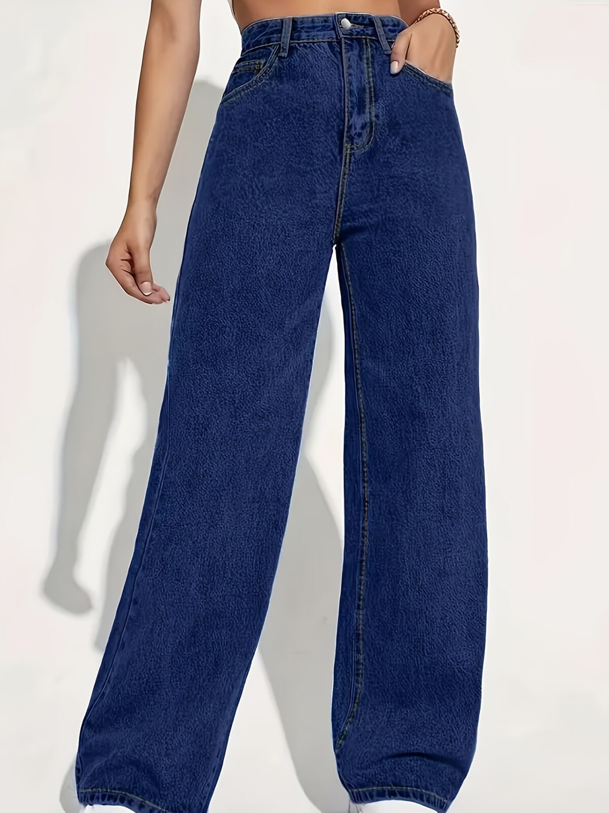 Model wearing Newness Dubai High Waisted Wide Leg Jeans a versatile pair of premium denim jeans in a flattering wide leg silhouette and high waisted fit perfect for any season