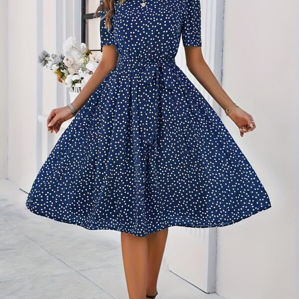 Timeless Polka Dot Swing Dress in a flattering A-line silhouette. Perfect for spring and summer.