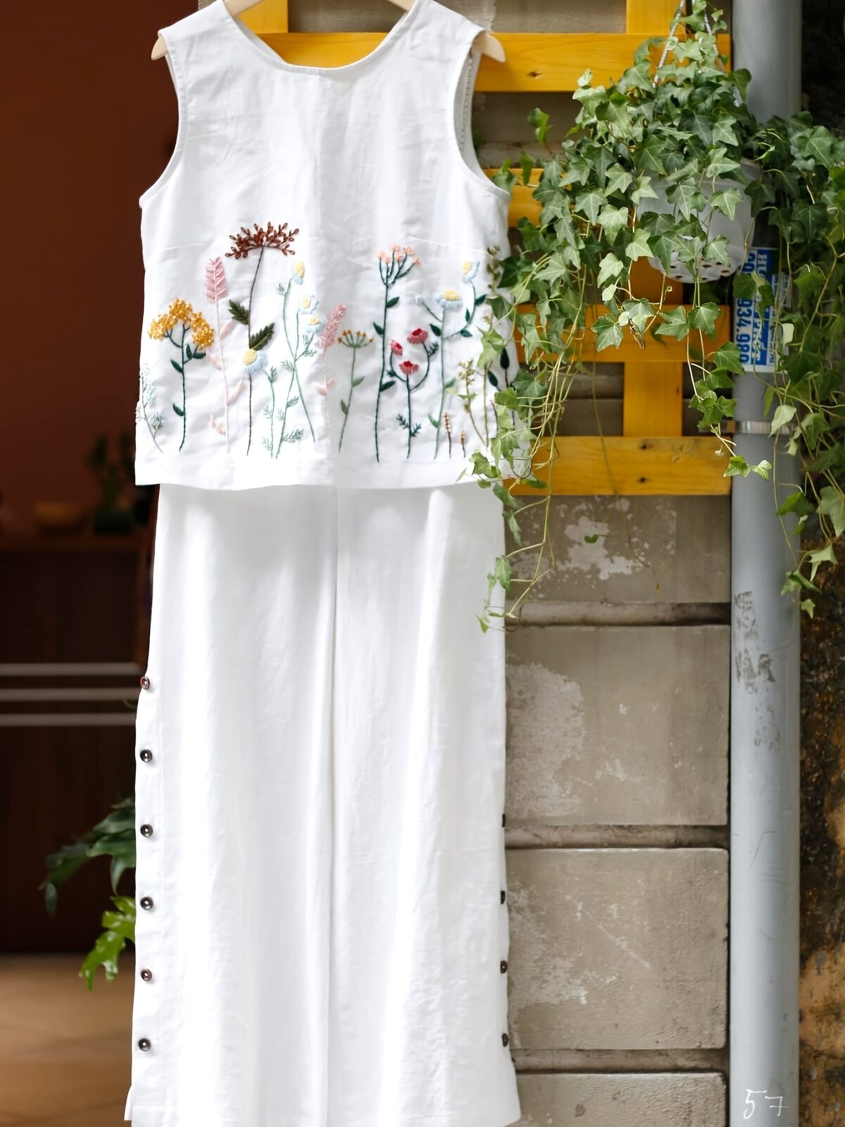 Embrace effortless chic in the Marrakech Sunset Embroidered Summer Jumpsuit This vibrant orange jumpsuit features intricate butterfly embroidery and a flattering wide leg silhouette