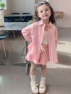 Adorable girl wearing Newness Riviera Chic summer outfit a stylish and breathable dress perfect for sunny days
