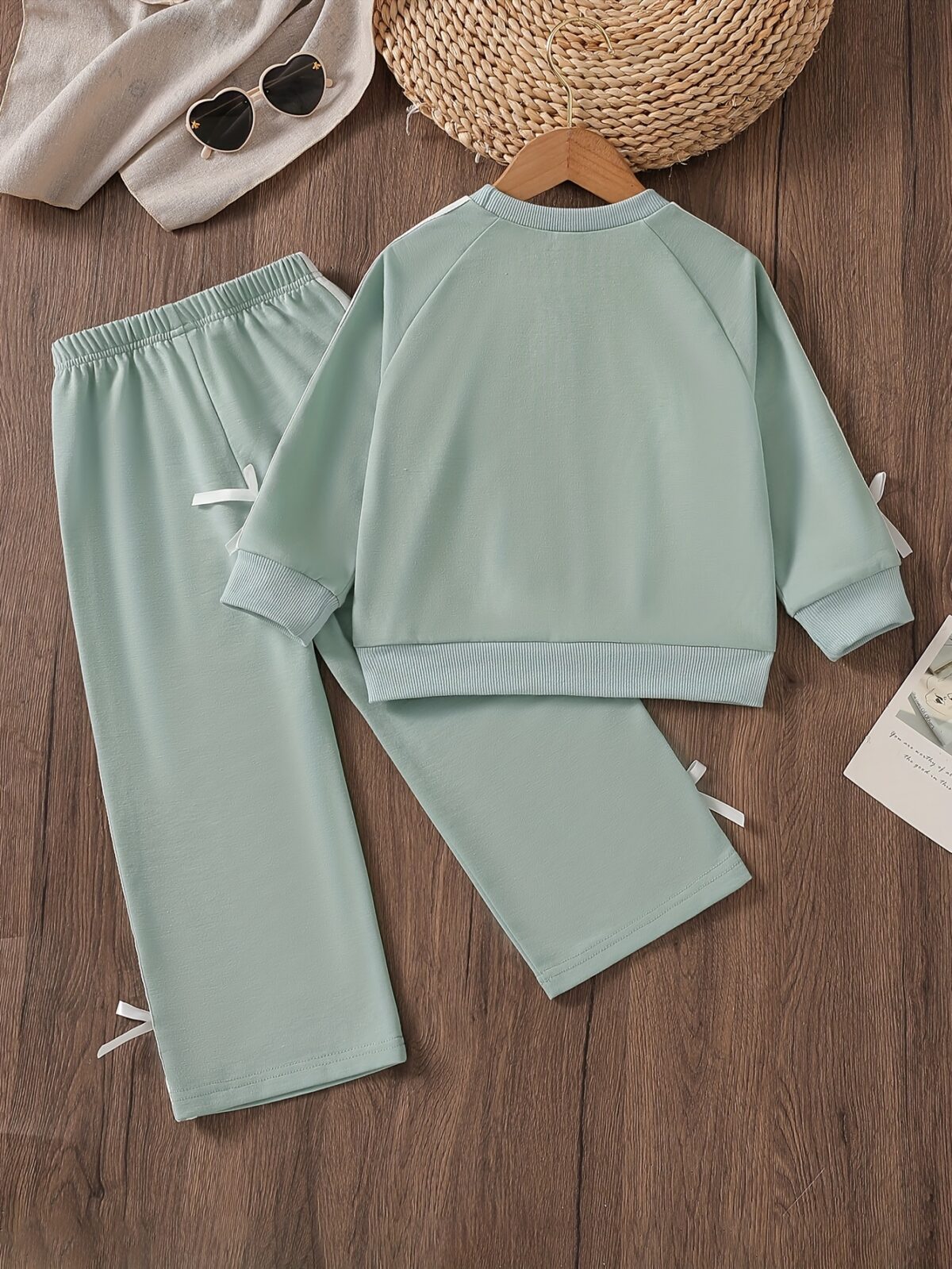 Girl wearing a stylish and comfortable two piece sweatpants set in soft stretchy fabric Perfect for everyday wear