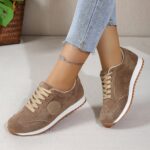 Womens classic flannel low top lace up sneakers with rubber sole shown from the side in a neutral color