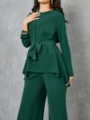 Sand colored polyester two piece pant set featuring a relaxed top and wide leg pants Model poses effortlessly chic
