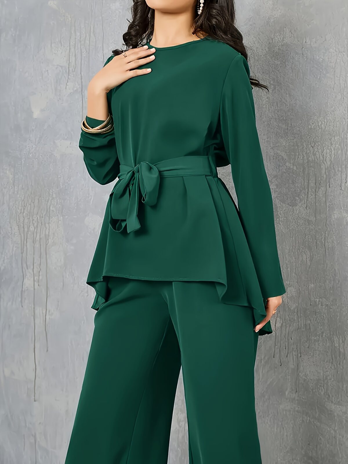 Sand colored polyester two piece pant set featuring a relaxed top and wide leg pants Model poses effortlessly chic