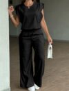 Model wearing the Newness Effortless Chic Sleeveless Wide Leg Set a stylish and comfortable two piece outfit featuring a sleeveless top and wide leg pants in luxurious polyester