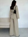 The Newness Milan Tie Waist Blazer Set a chic two piece outfit featuring a tailored blazer and matching pants cinched at the waist for a flattering silhouette Perfect for work or weekend