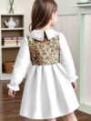 Newness Kensington Jacquard Floral Dress A chic and elegant floral dress perfect for spring Close up view showing the intricate jacquard fabric and flattering silhouette