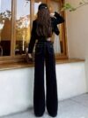 Newness Midnight Hour Black High Waisted Jeans A model showcasing the flattering fit and chic style of the jeans