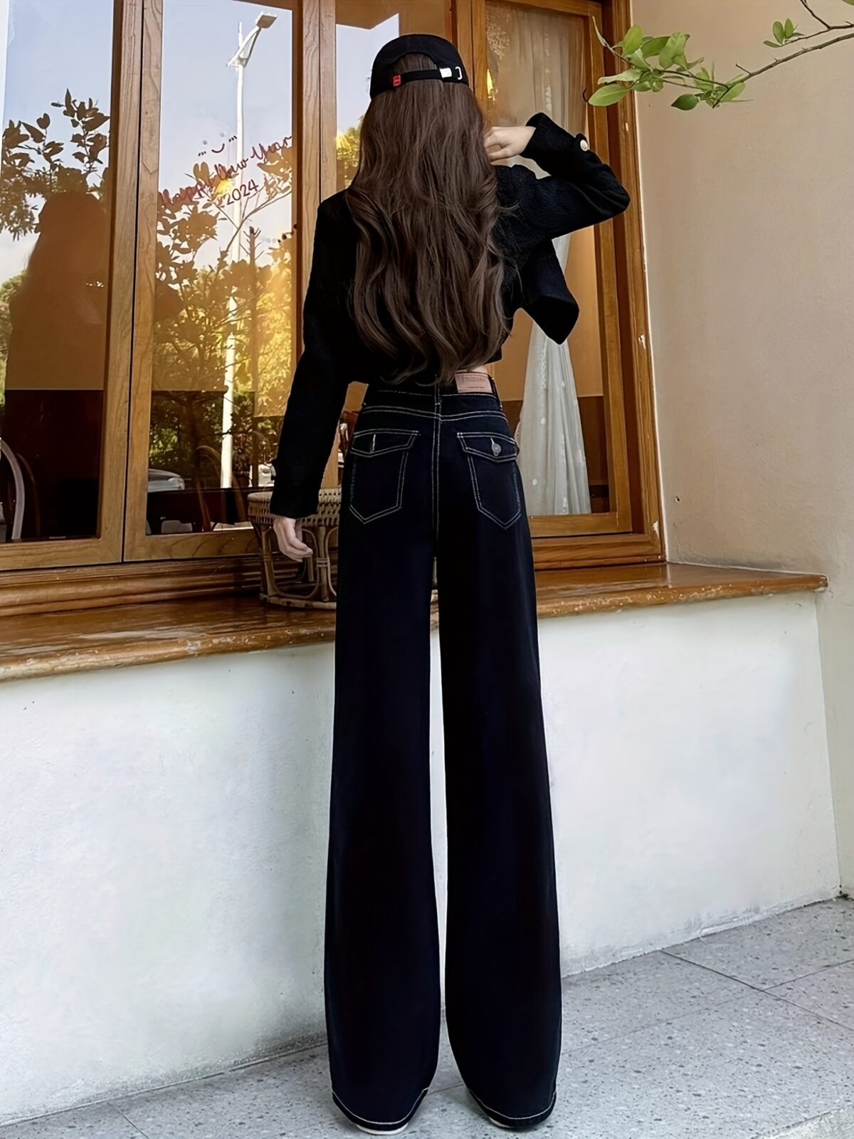 Newness Midnight Hour Black High Waisted Jeans A model showcasing the flattering fit and chic style of the jeans