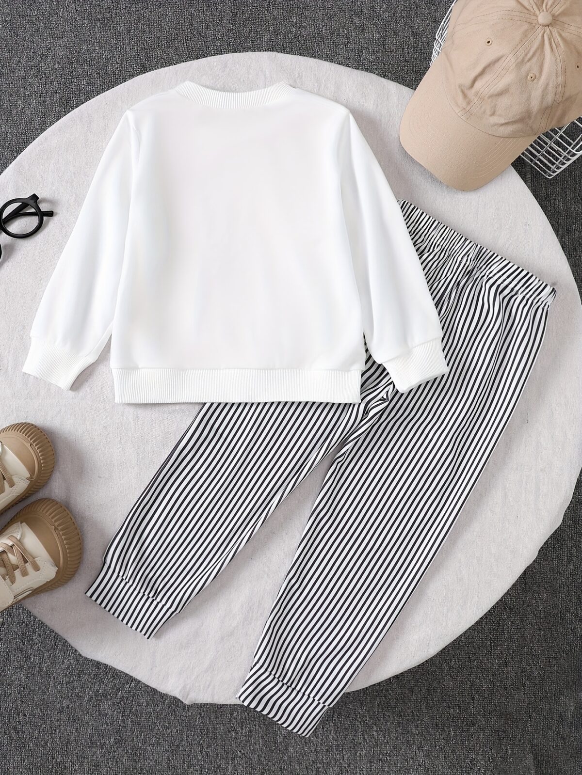 Adorable boys hoodie and sweatpants set featuring a stylish pencil pattern hoodie and comfortable striped sweatpants Perfect for school playdates or cozy days at home