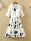 Model wearing the Newness Summer Solstice Floral Print Dress a chic and flattering midi dress with a retro inspired floral print perfect for summer