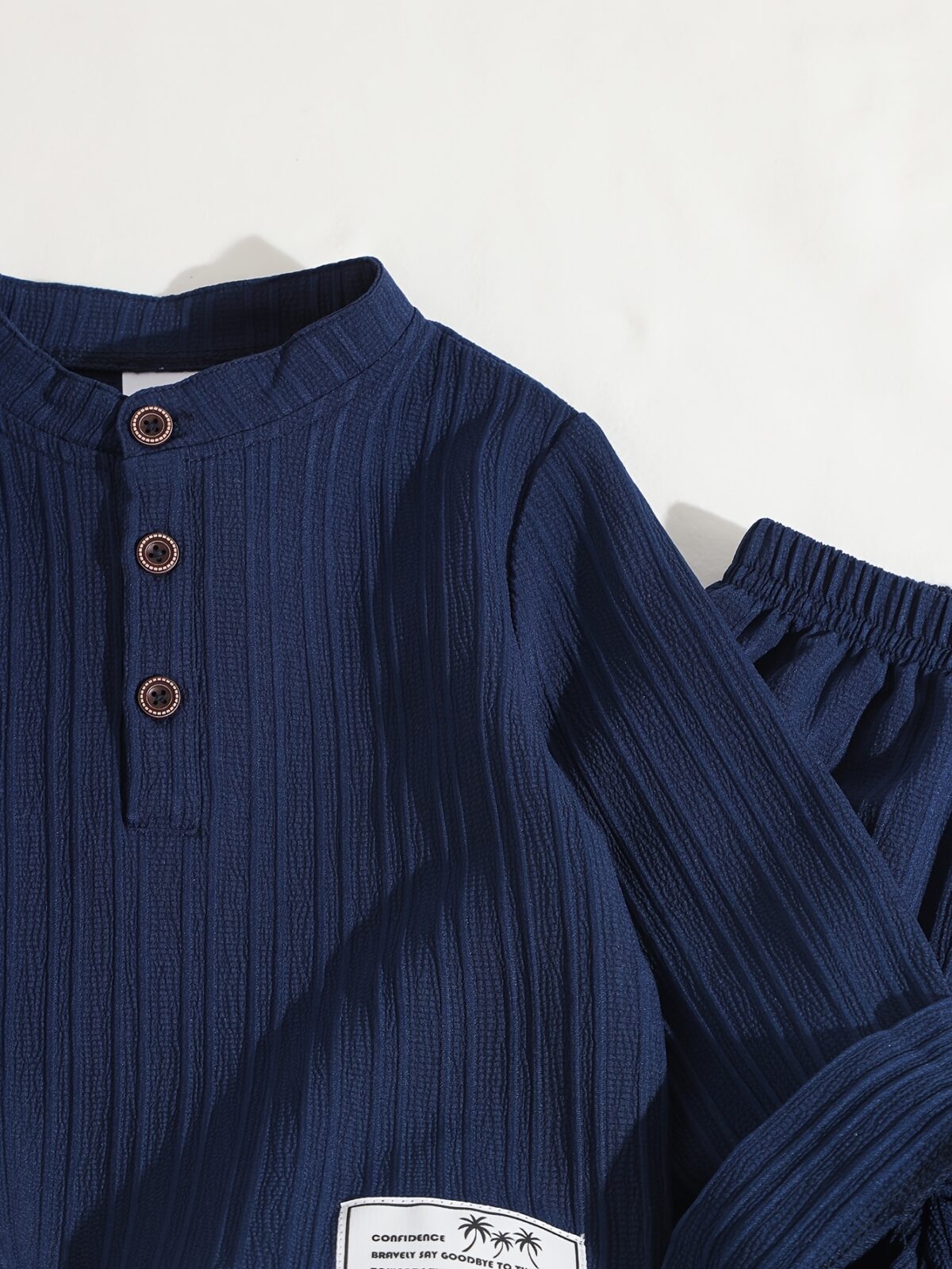 Stylish boys two piece outfit in a trendy striped pattern featuring a comfortable stand collar shirt and cuffed pants perfect for spring or autumn